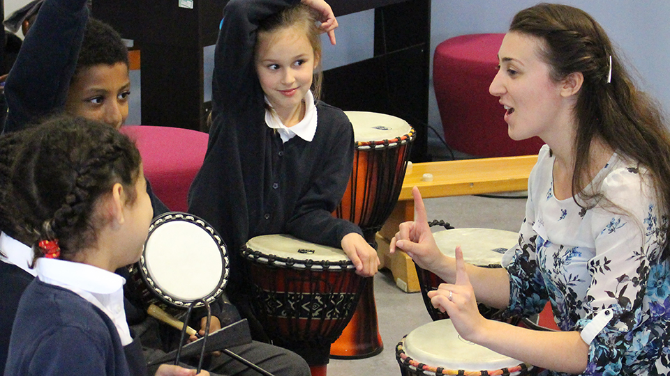 Lydia Baldwin from the RCM interacting with children in school