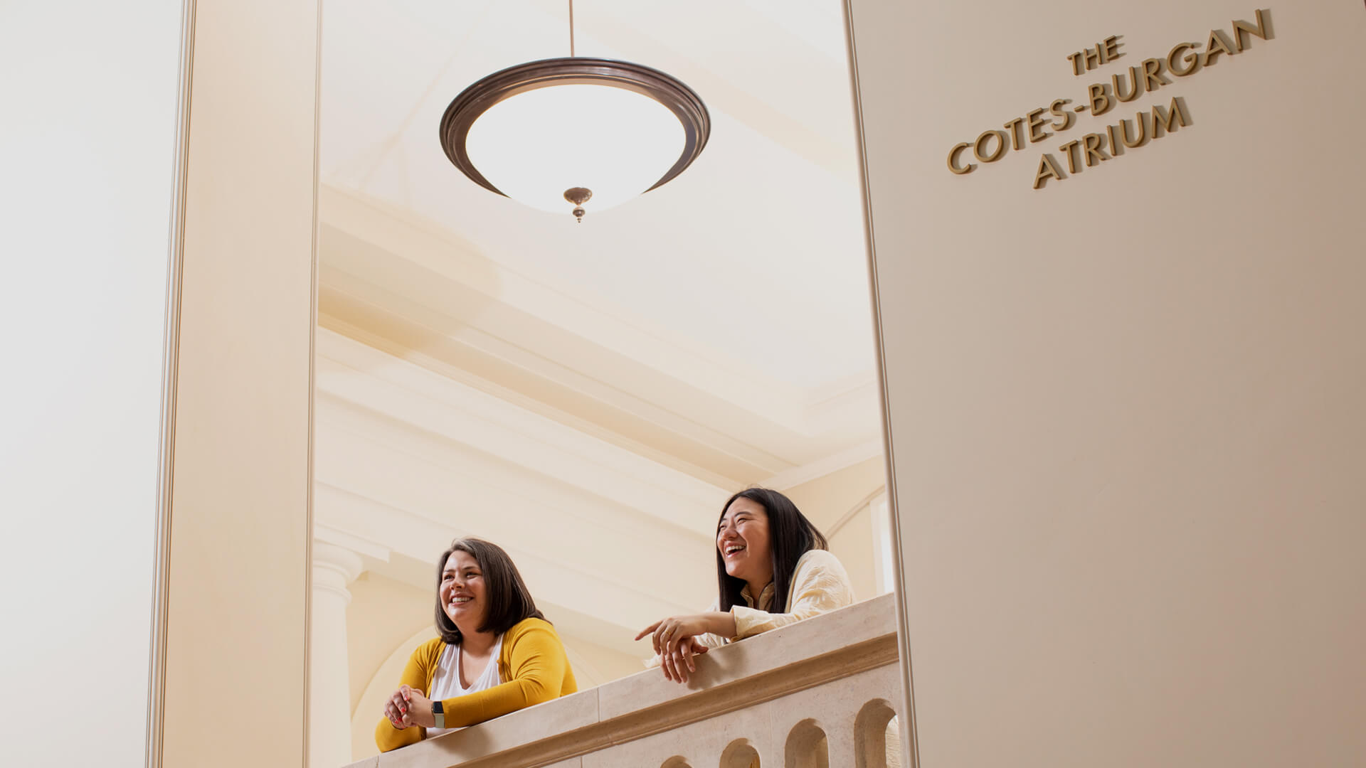 Two people at the RCM looking out over the new atrium