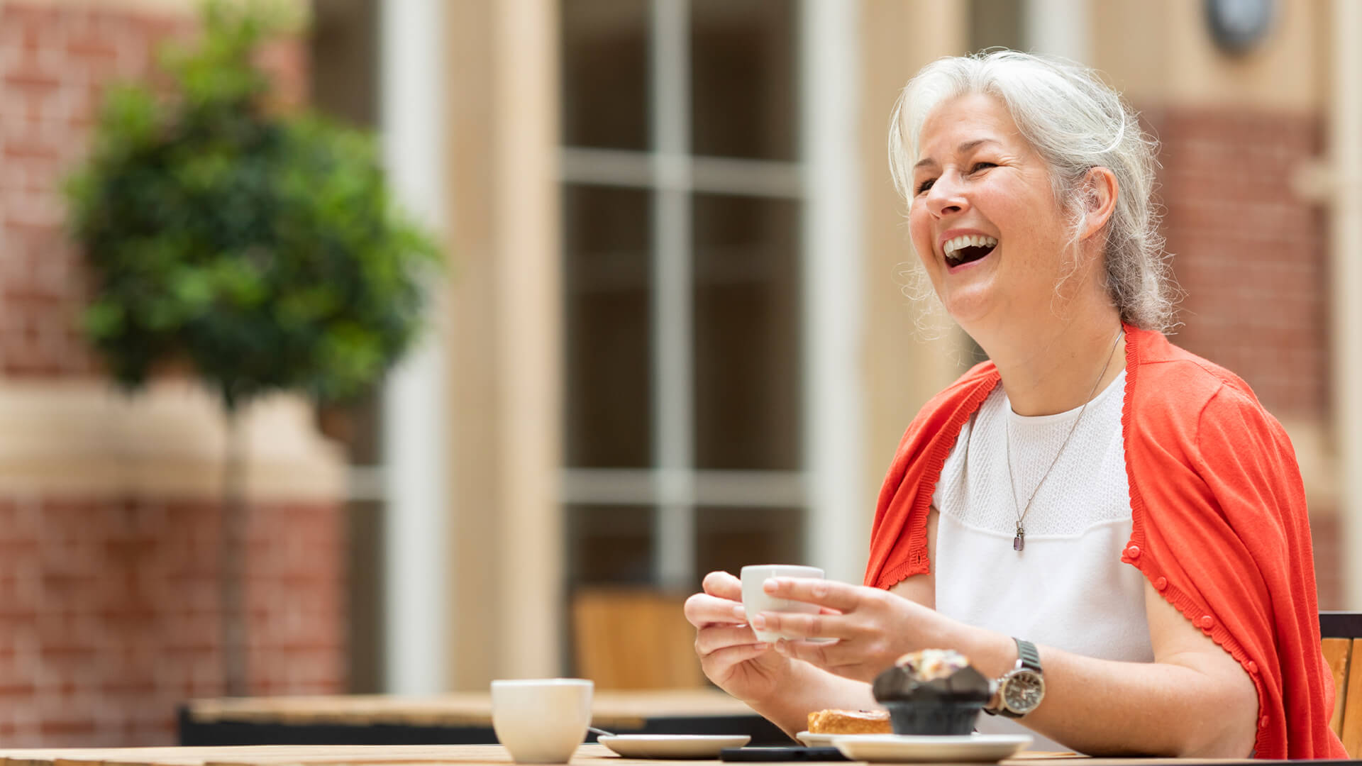 A woman enjoying a drink in the RCM cafe