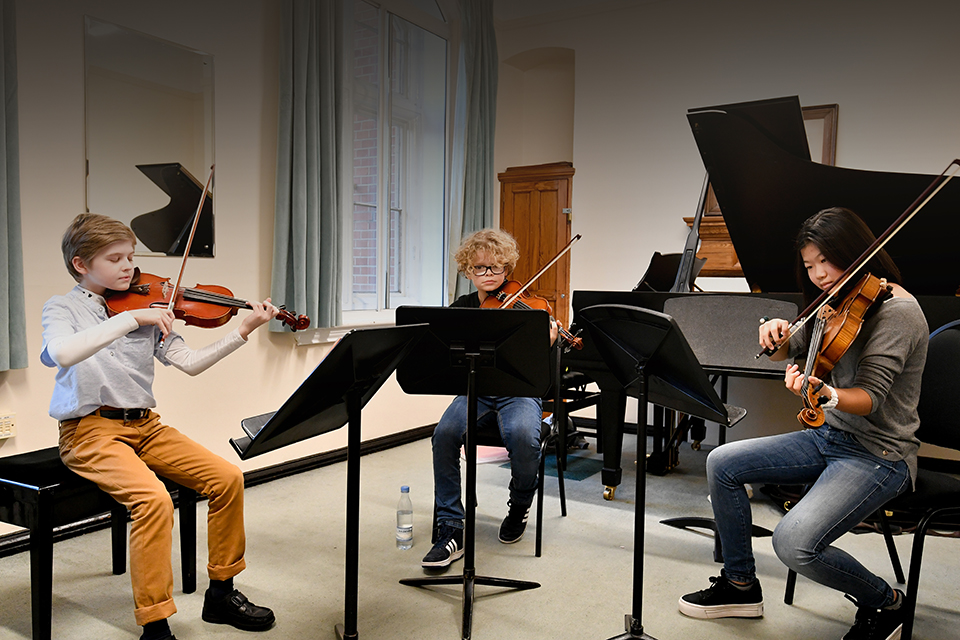 3 RCMJD students rehearsing 3 RCMJD students rehearsing