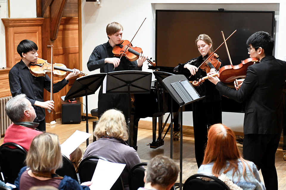 A string quartet performs in the Carne Room