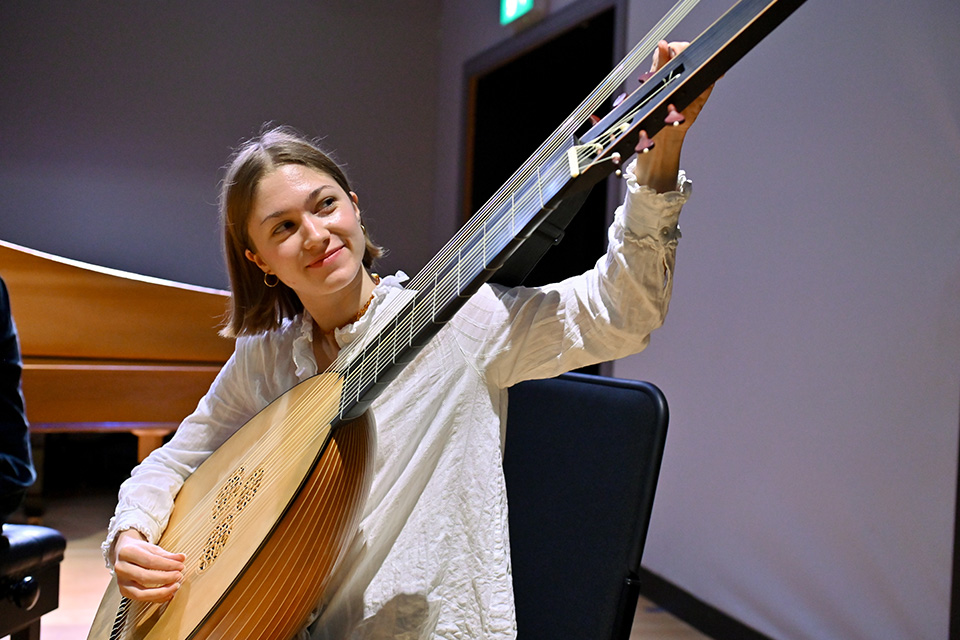 A girl plays a historical lute