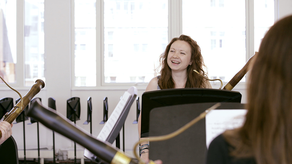 A female bassoonist smiles during a rehearsal A female bassoonist smiles during a rehearsal
