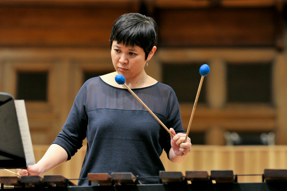 Visiting artist She-e Wu playing the marimba and looking at music