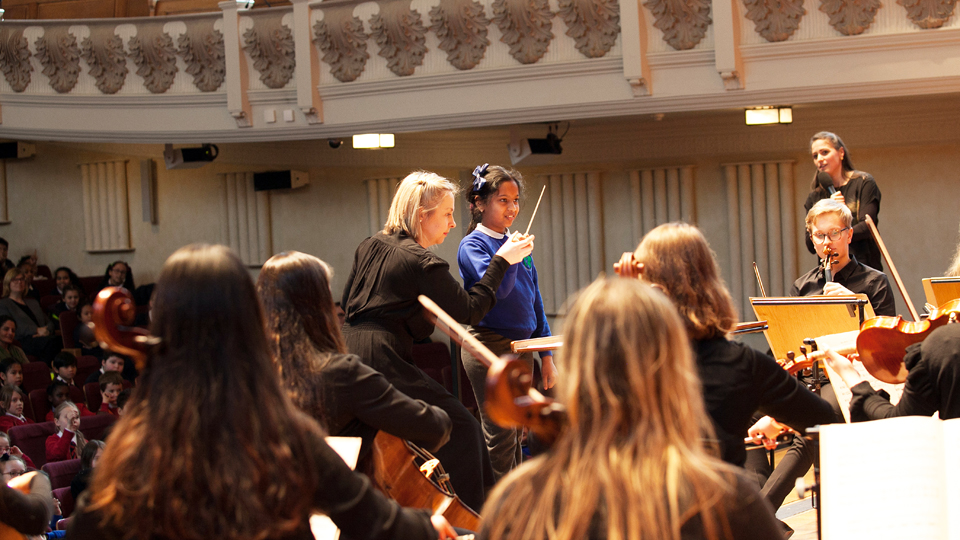 Pupil conducting at a Sparks lunchtime concert for schools Pupil conducting at a Sparks lunchtime concert for schools